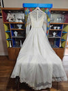 Vintage white wedding dress with gold lace and train