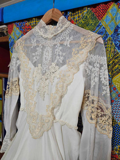 Vintage white wedding dress with gold lace and train